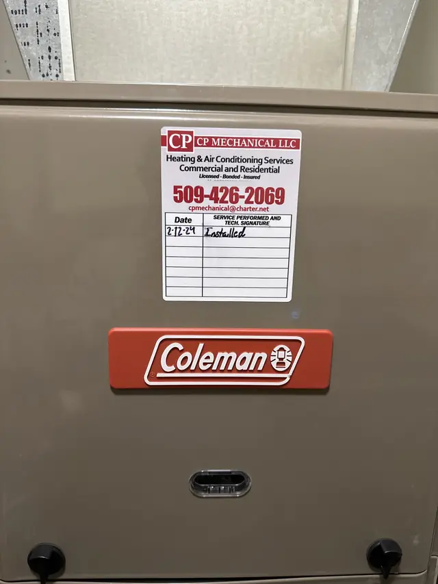 A Coleman gas furnace with CP Mechanical's red-and-white service sticker on the door, dated 2-12-24, Installed